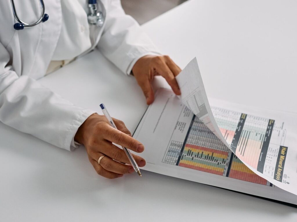 A clinician reviewing a medical chart at a desk.