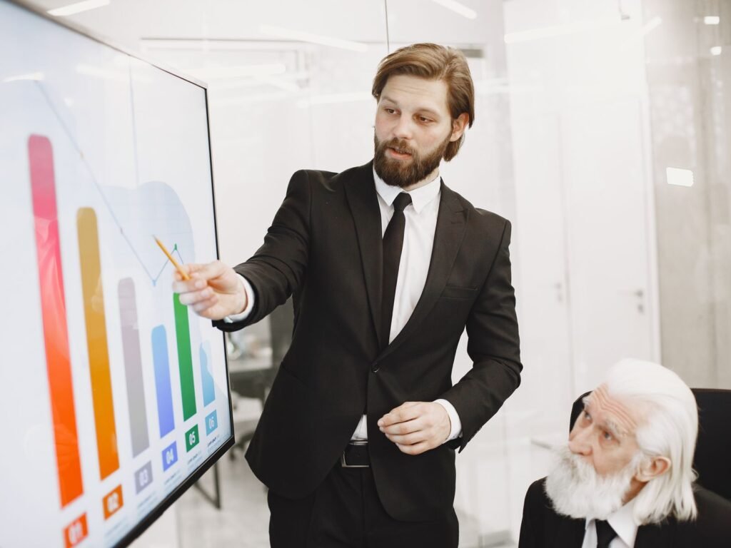 Business colleagues reviewing a financial chart during a presentation.