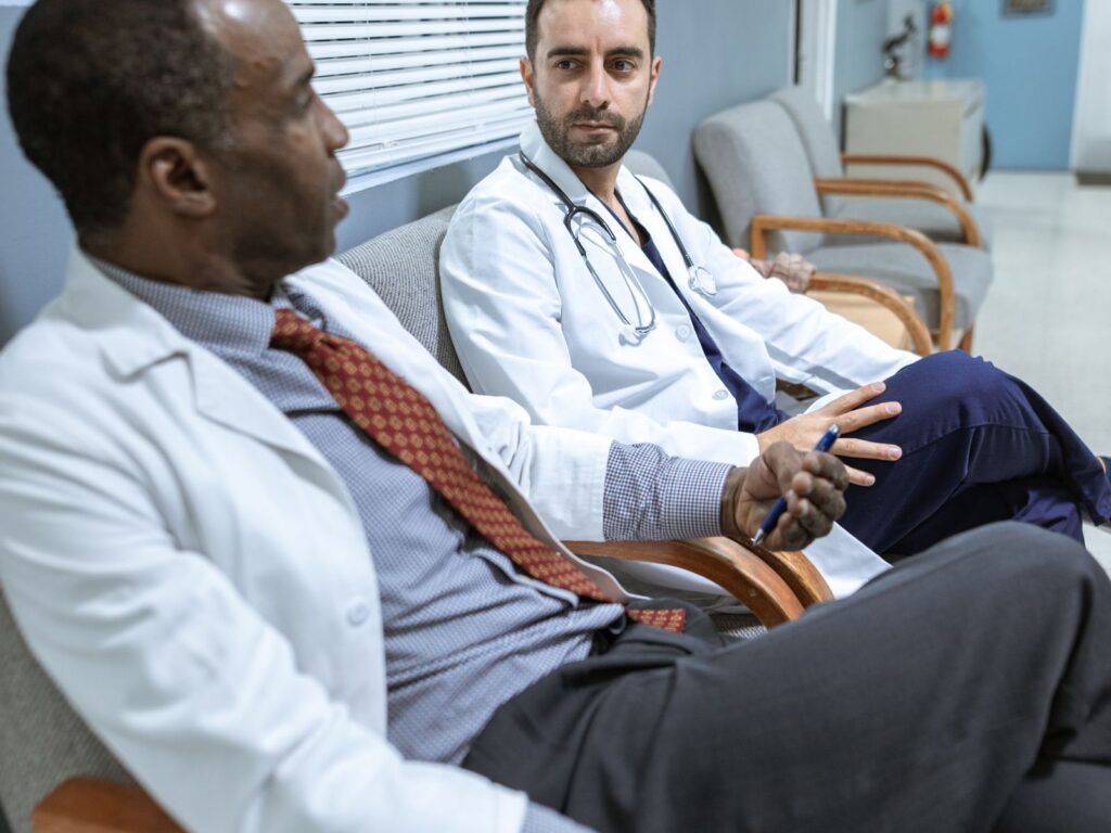 Two physicians discussing a plan in a clinical setting.