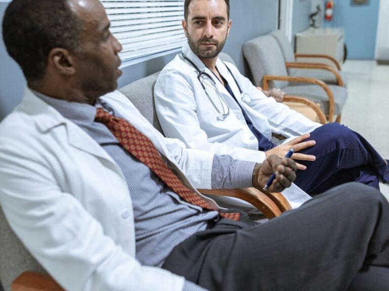 Two physicians discussing a plan in a clinical setting.