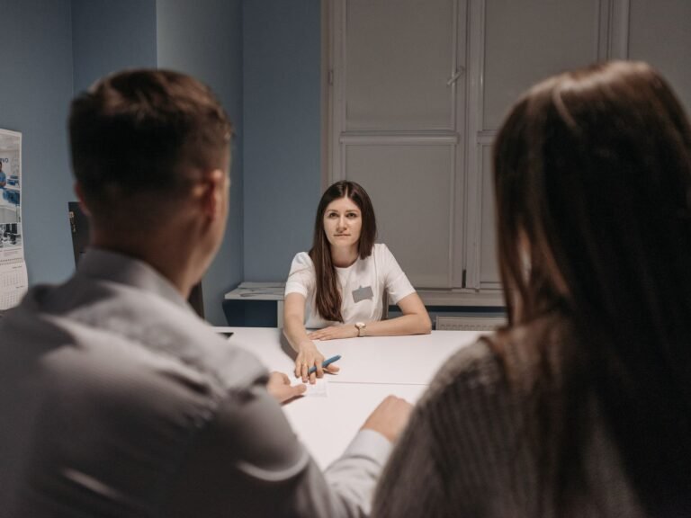 Healthcare professionals meeting around a table to review a plan.