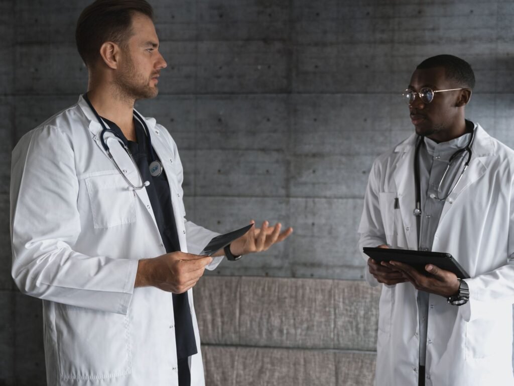 Two physicians reviewing information while discussing a career decision.